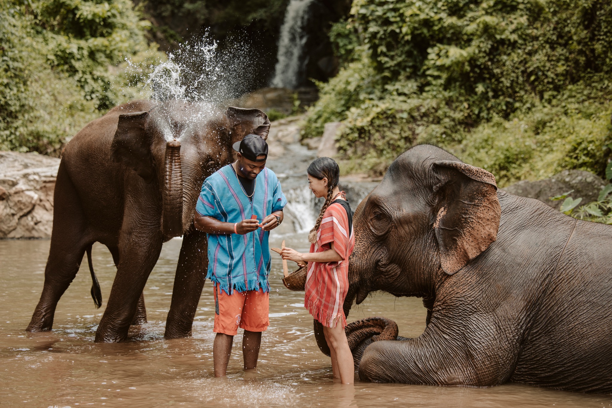 Stephanie and Quay enjoying the water with elephants