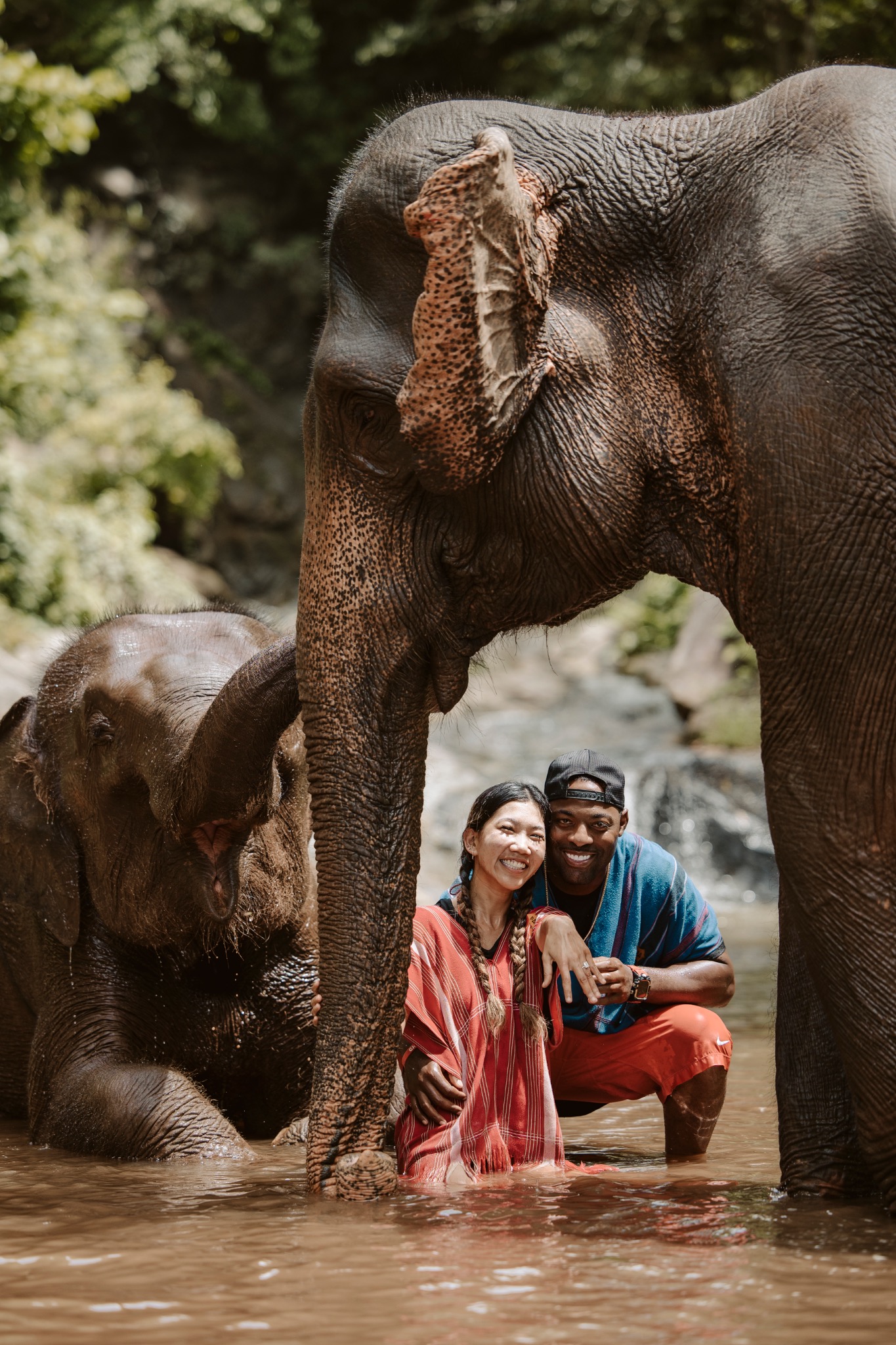 Stephanie and Quay posing beneath an elephant