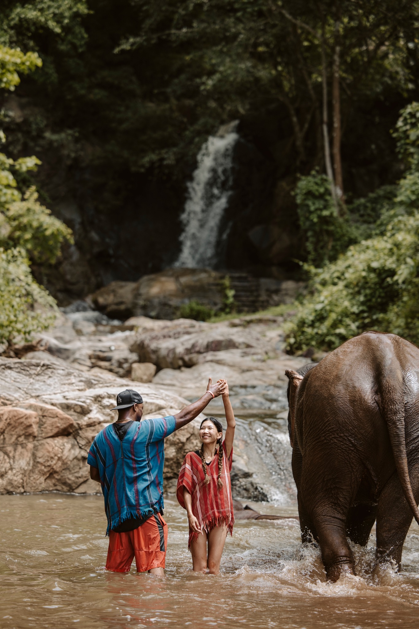 Stephanie and Quay in the river near a waterfall