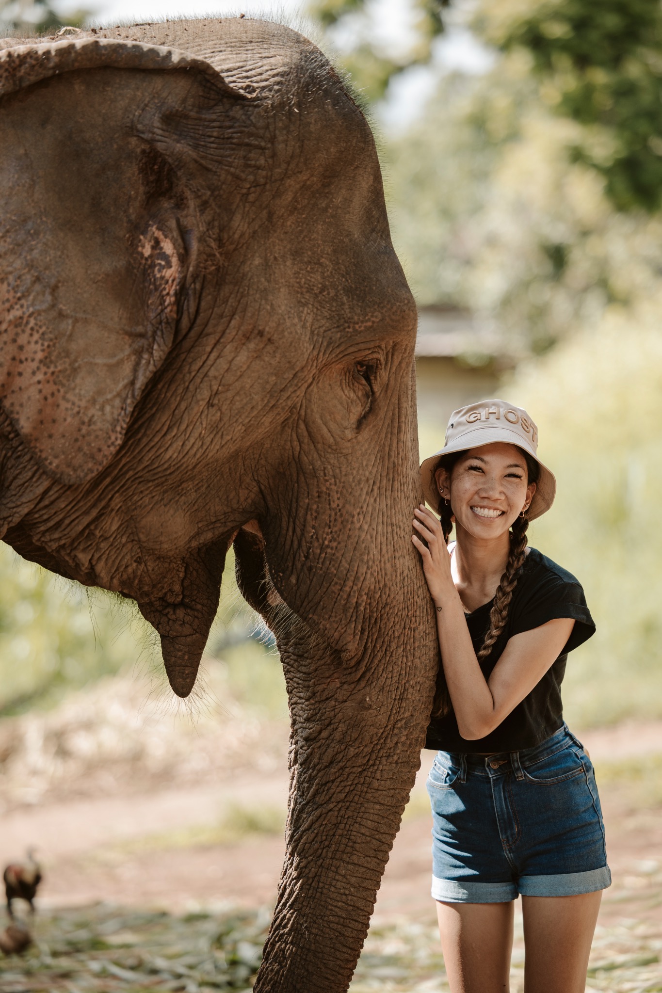 Stephanie smiling beside an elephant