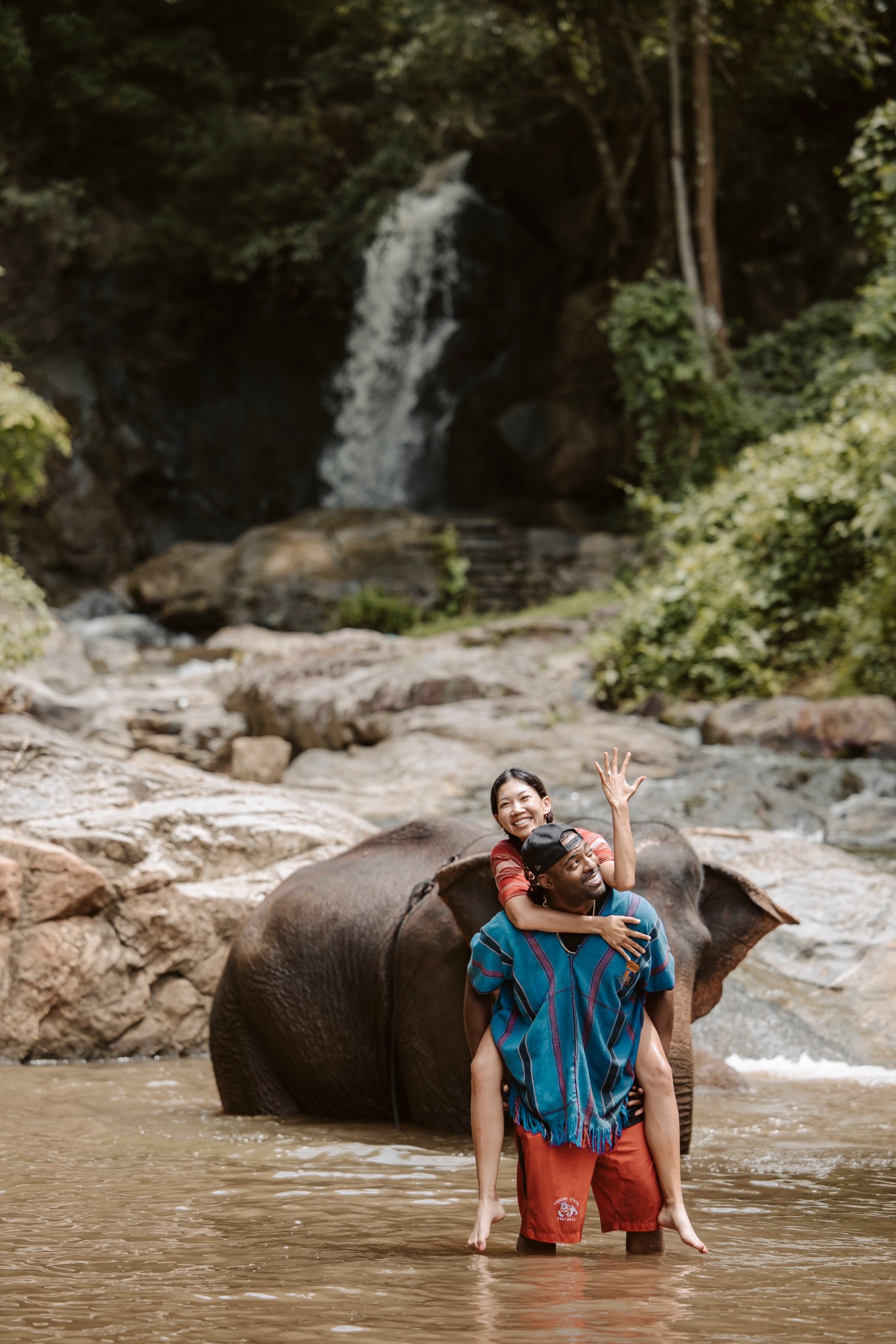 Stephanie and Quay beside an elephant in the water