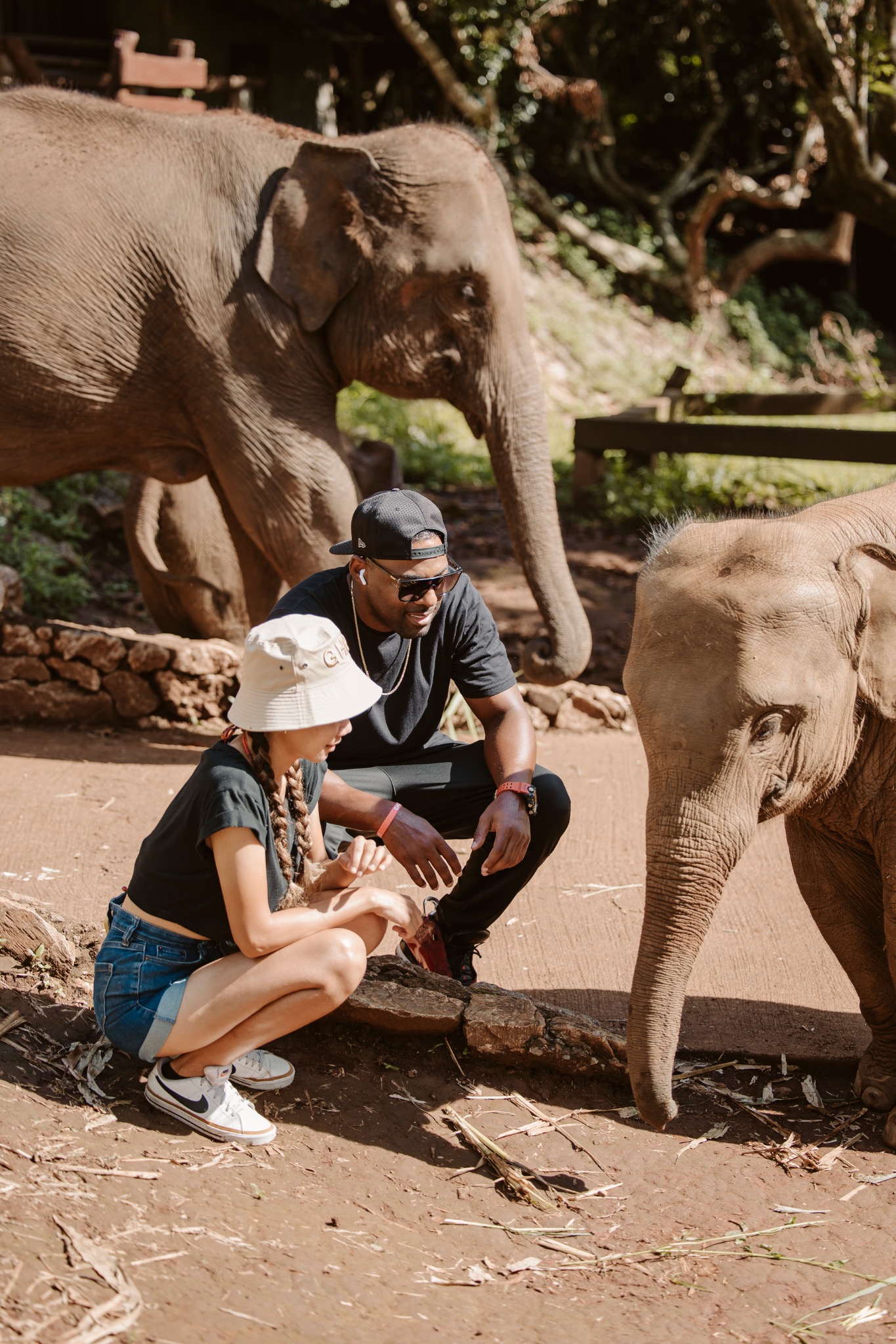 Stephanie and Quay sitting with an elephant
