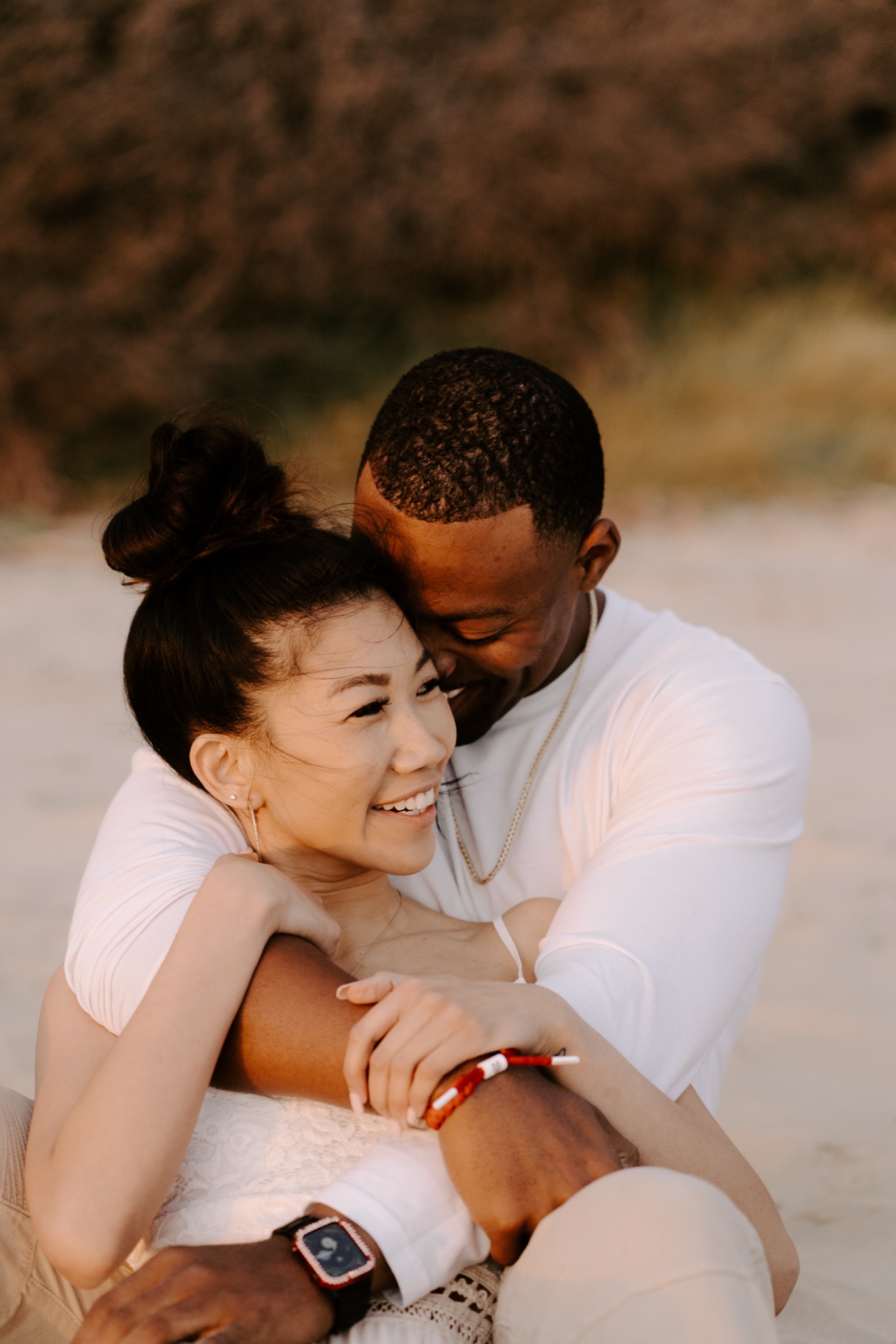 Stephanie and Quay embracing by the coast