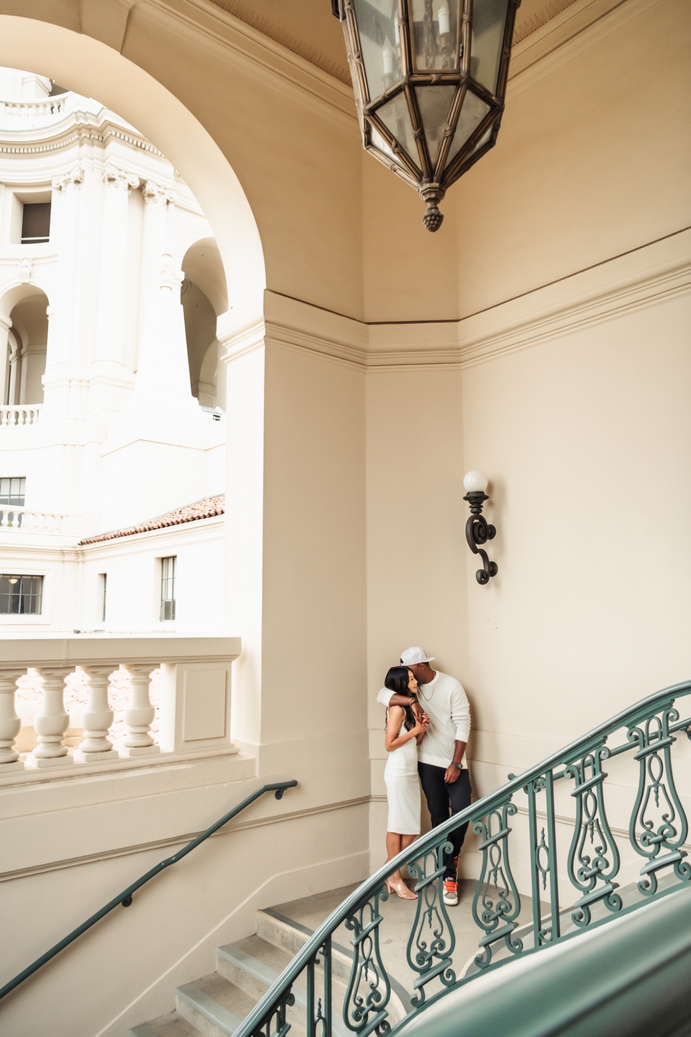 Stephanie and Quay beside a curved stairway